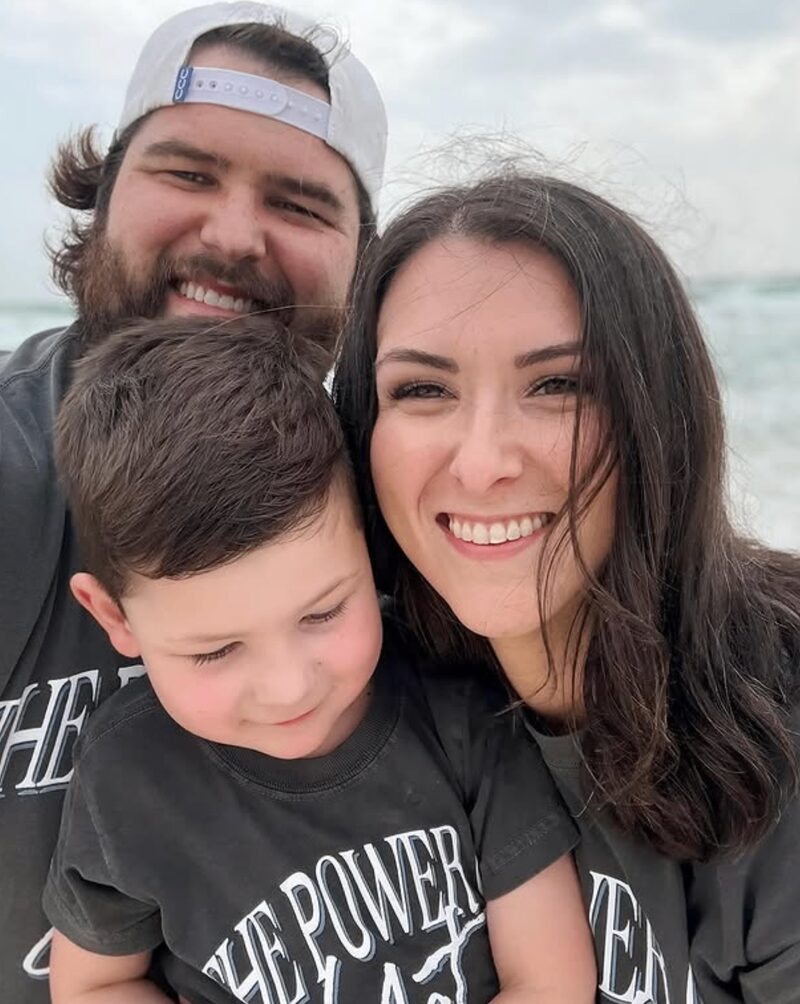 Family wearing matching fundraiser t-shirts at the beach
