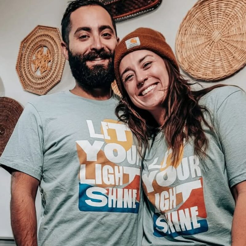 Couple in matching Let Your Light Shine fundraiser tees