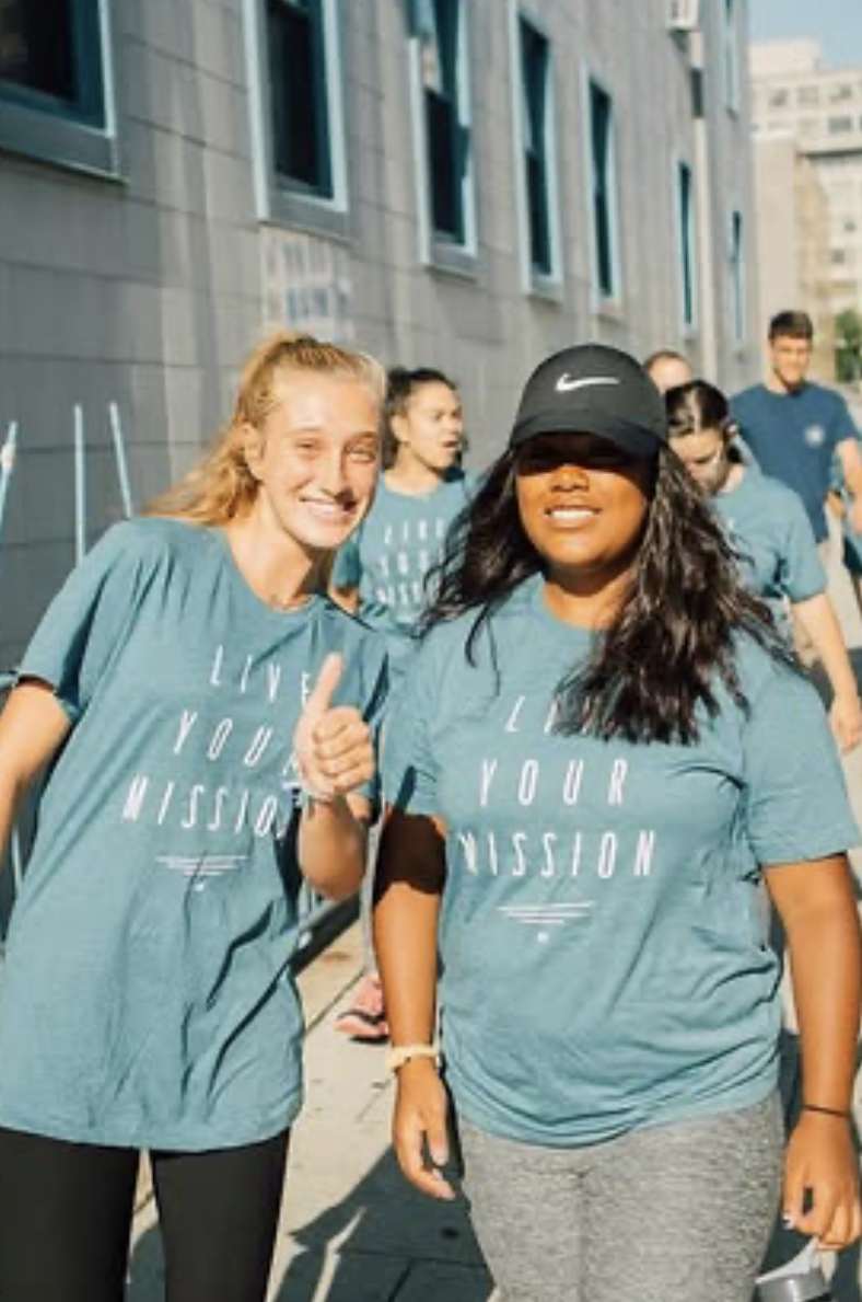 Team in matching Live Your Mission tees on a service trip
