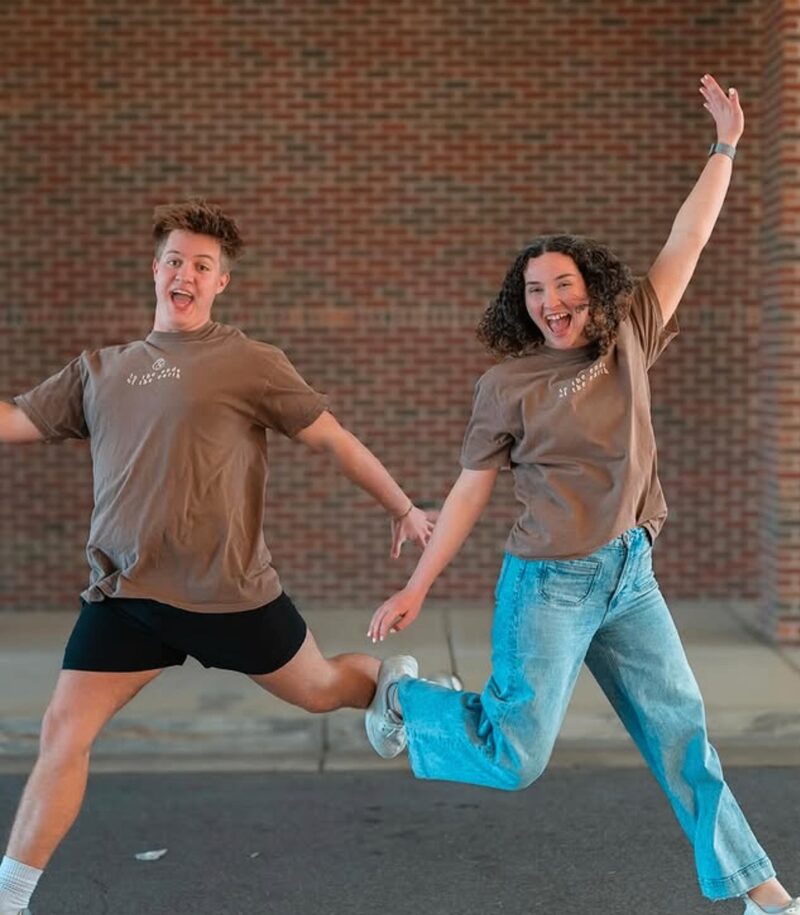 Students celebrating in brown fundraiser t-shirts